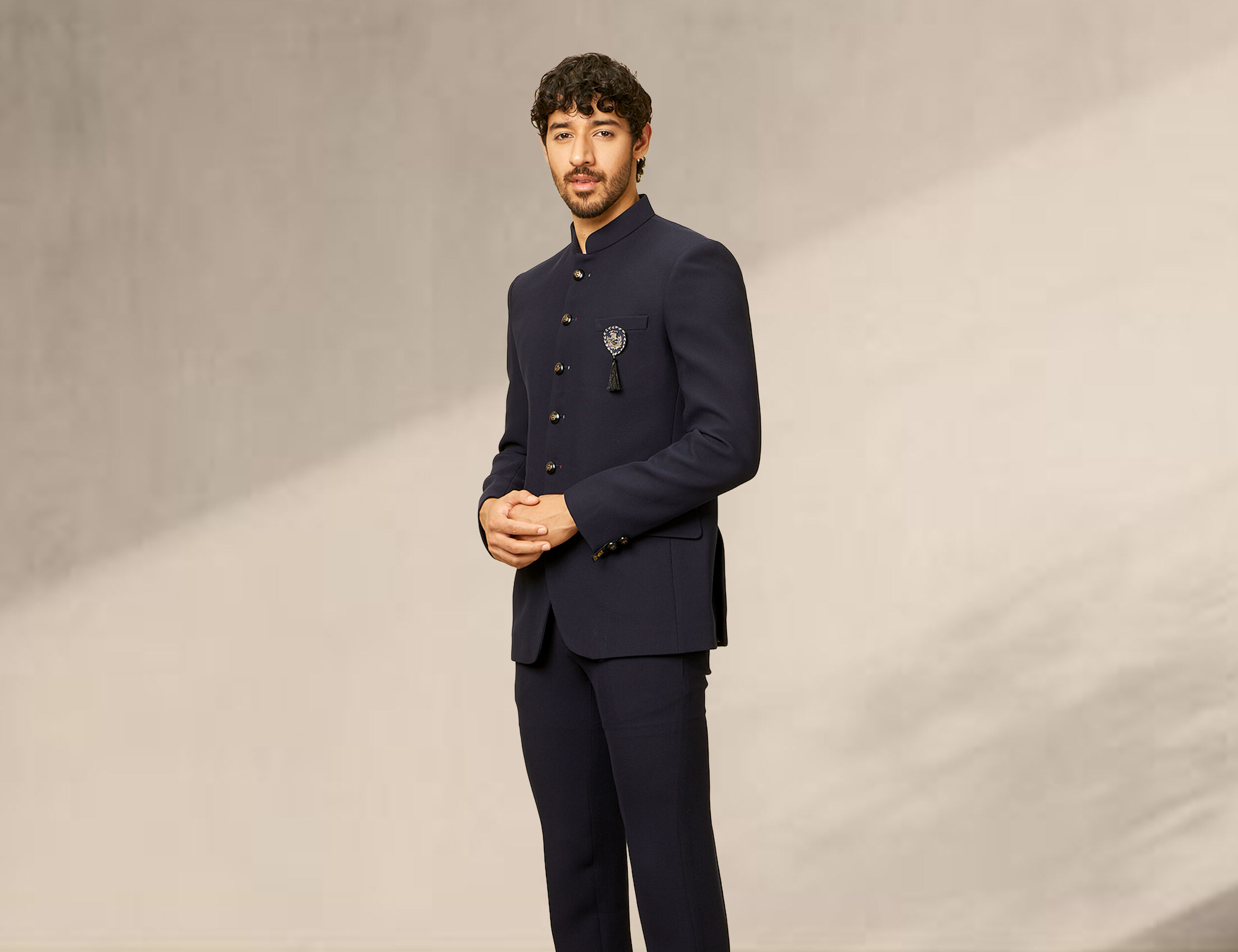 Man dressed in a simple blue silk Jodhpuri suit, perfect for wedding functions.